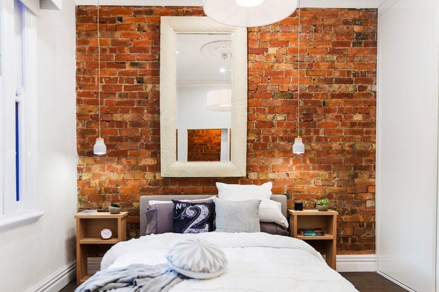Bedroom with exposed red brick
