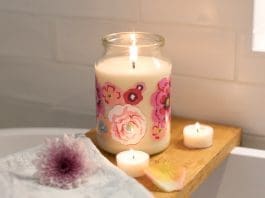 Burning candle on shelf