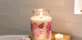Burning candle on shelf