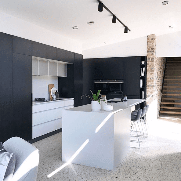Black and white kitchen with perforated steel detail