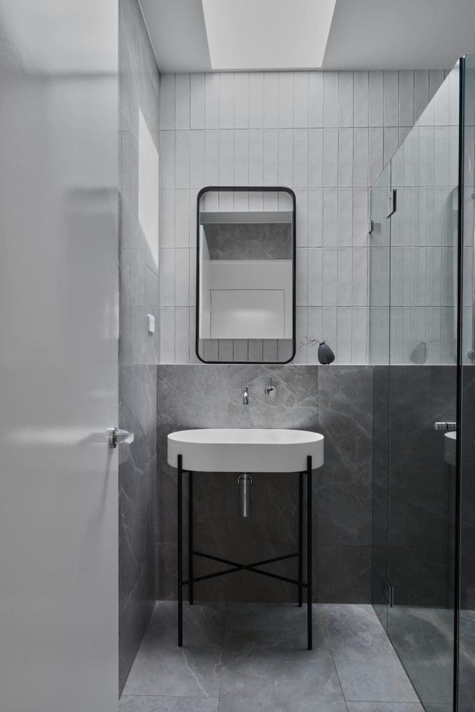 Powder room rectangular rounded mirror and standalone sink