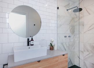 White bathroom with statement round mirror