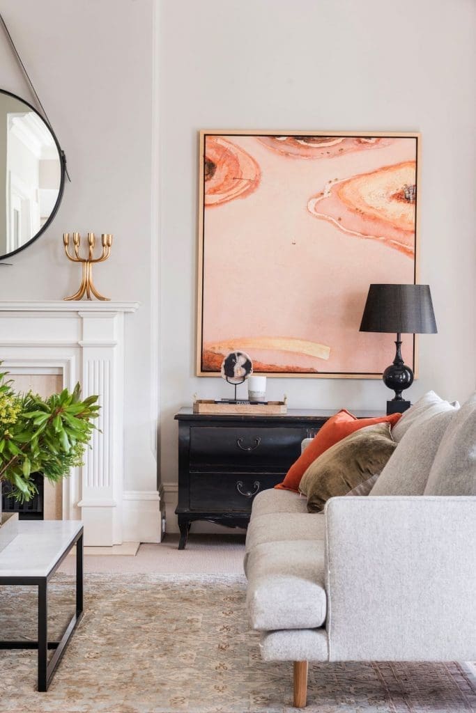 Large peach tone artwork in traditional living room