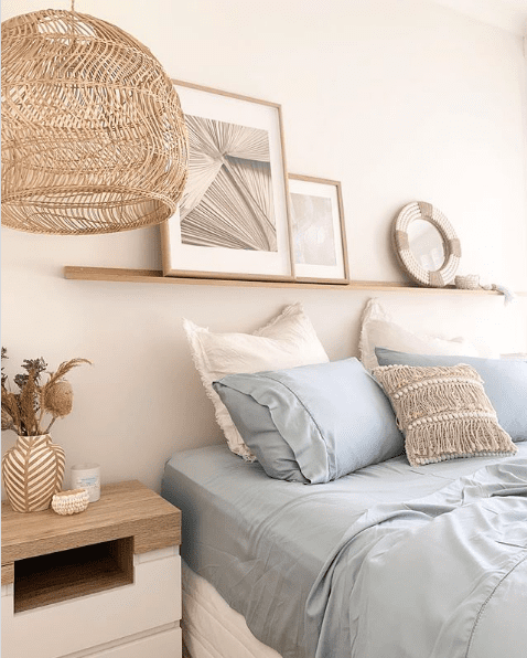 Bedroom with green bedding and basket light