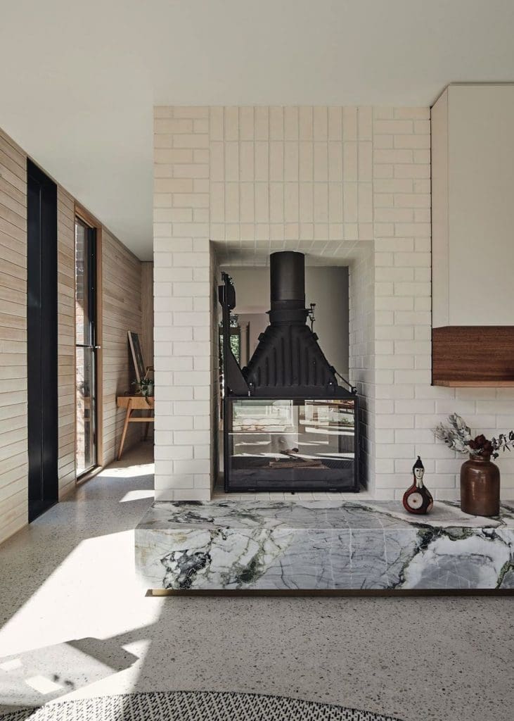 Two way fireplace with stone plinth