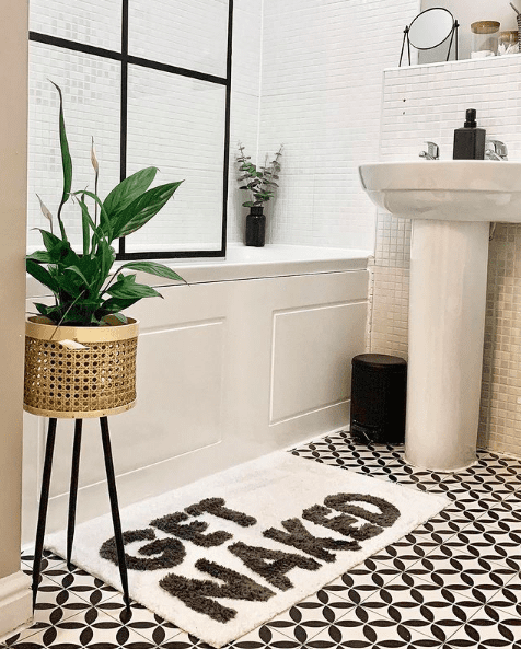Peace lily in white and black bathroom