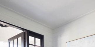 Modern country style laundry with green cabinetry