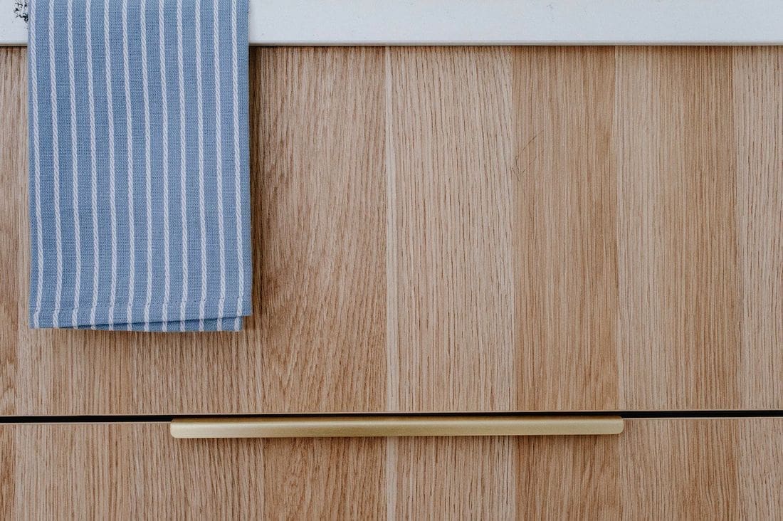 Timber cabinetry with gold pull handles