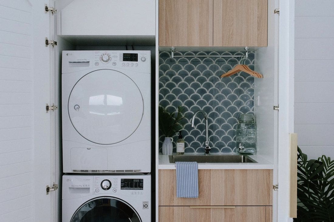 Under-stair laundry with stacked washer dryer