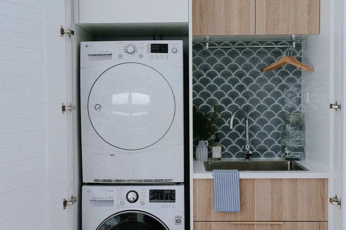 Under-stair laundry with stacked washer dryer
