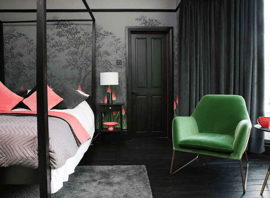 Eclectic bedroom with wallpaper and black floors