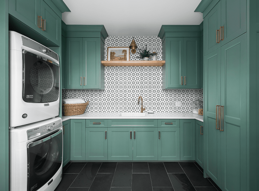 Laundry and mudroom with green cabinetry