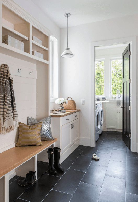 Laundry and mudroom with black ceramic floors