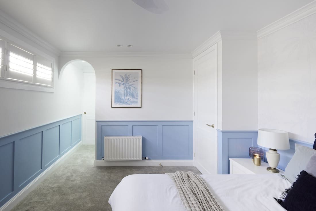 Blue wainscoating in Hamptons bedroom