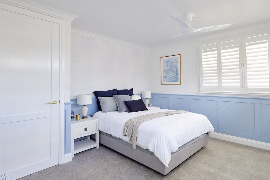 Hamptons style guest bedroom with plantation shutters