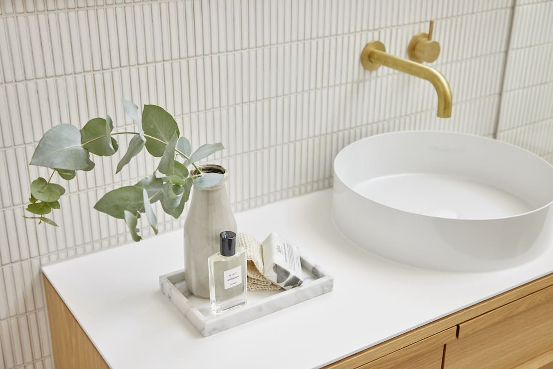Bathroom vanity styling with tray and white kit kat tiles
