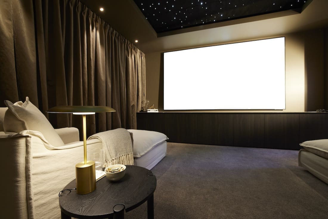 At home cinema set up in basement with large projector screen