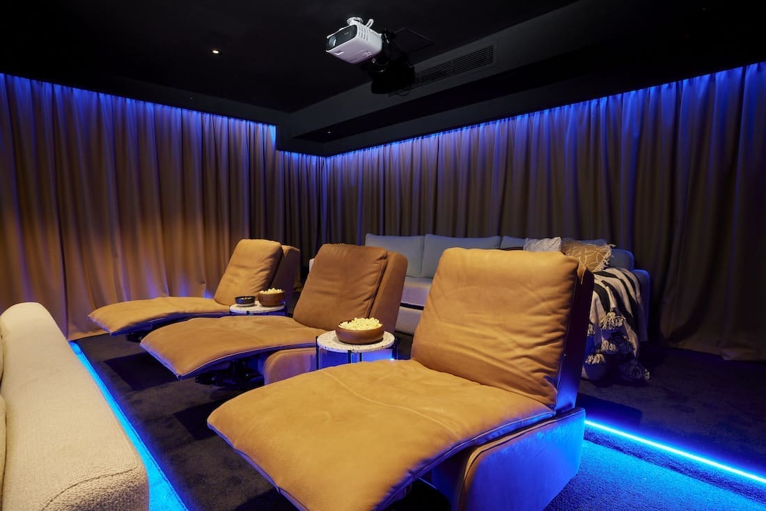 Recliners in home cinema with blue LED lights