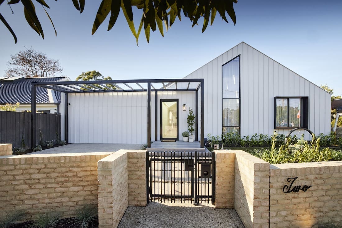 Brick fence in front of standing-seam Colorbond clad façade