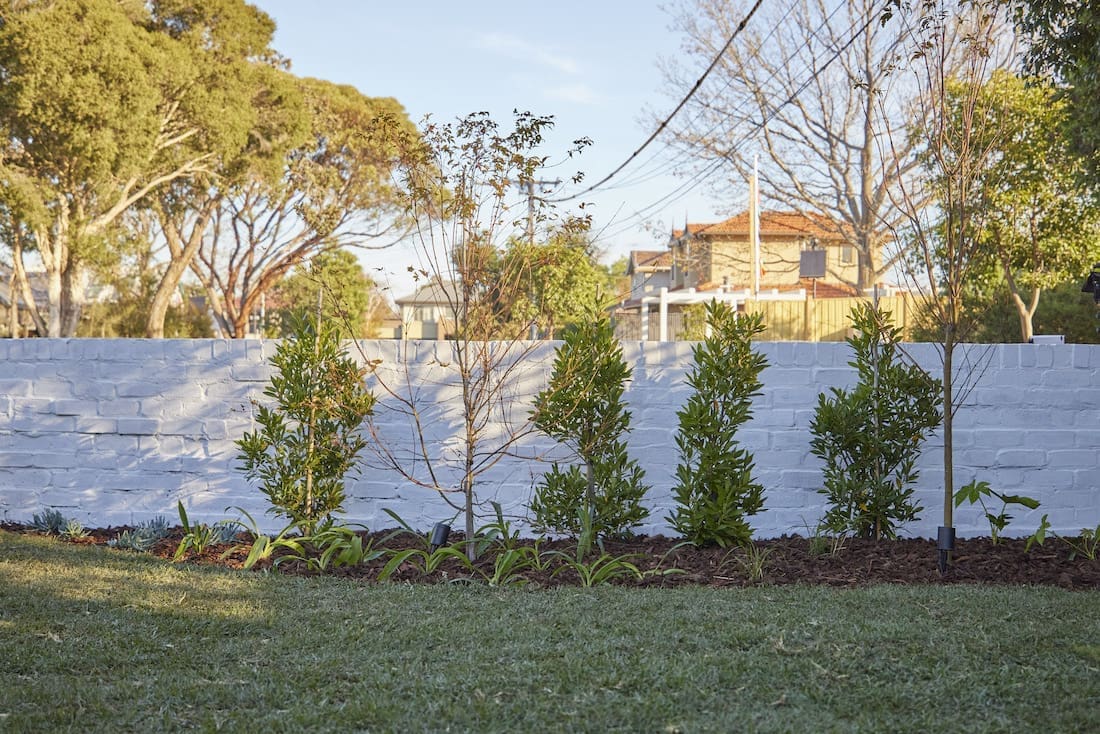 White painted brick fence