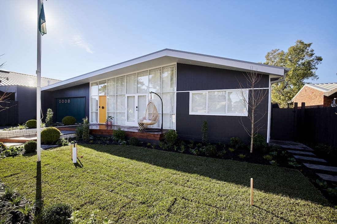 Black house with yellow front door
