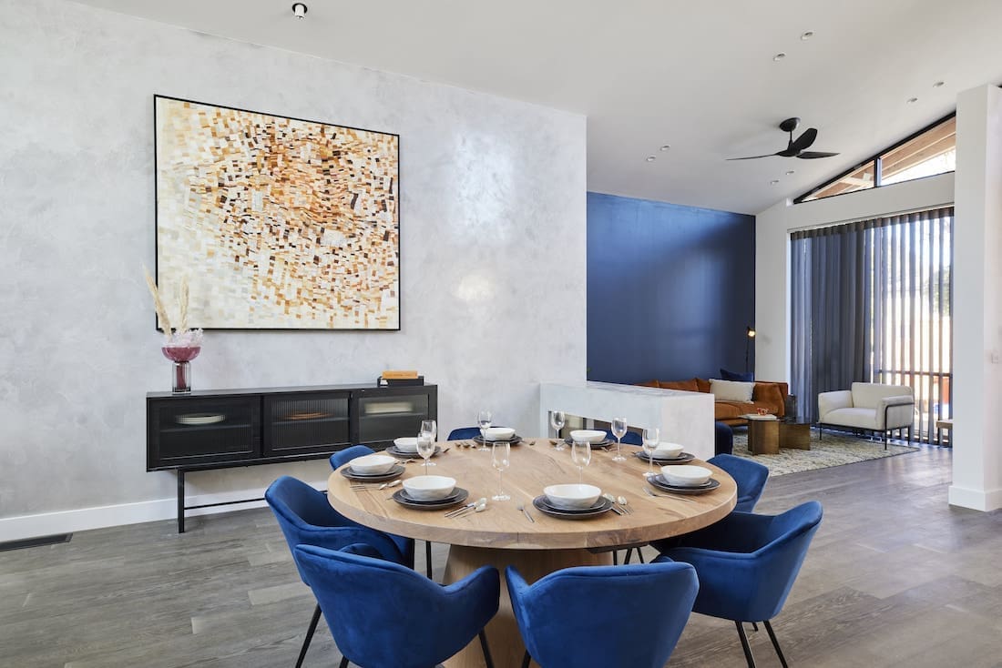 Round dining table with blue velvet chairs