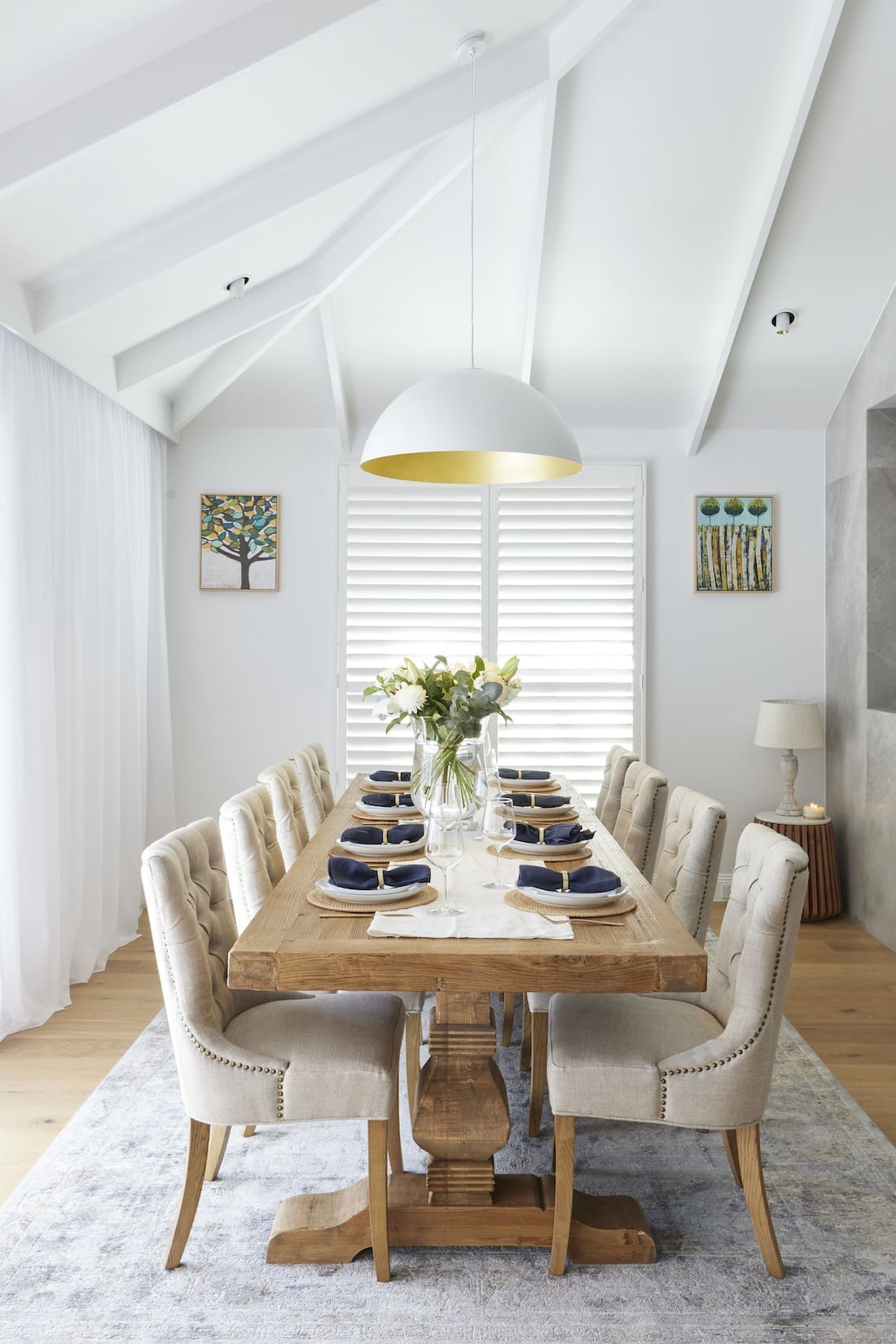 White dome light in raked ceiling above dining table