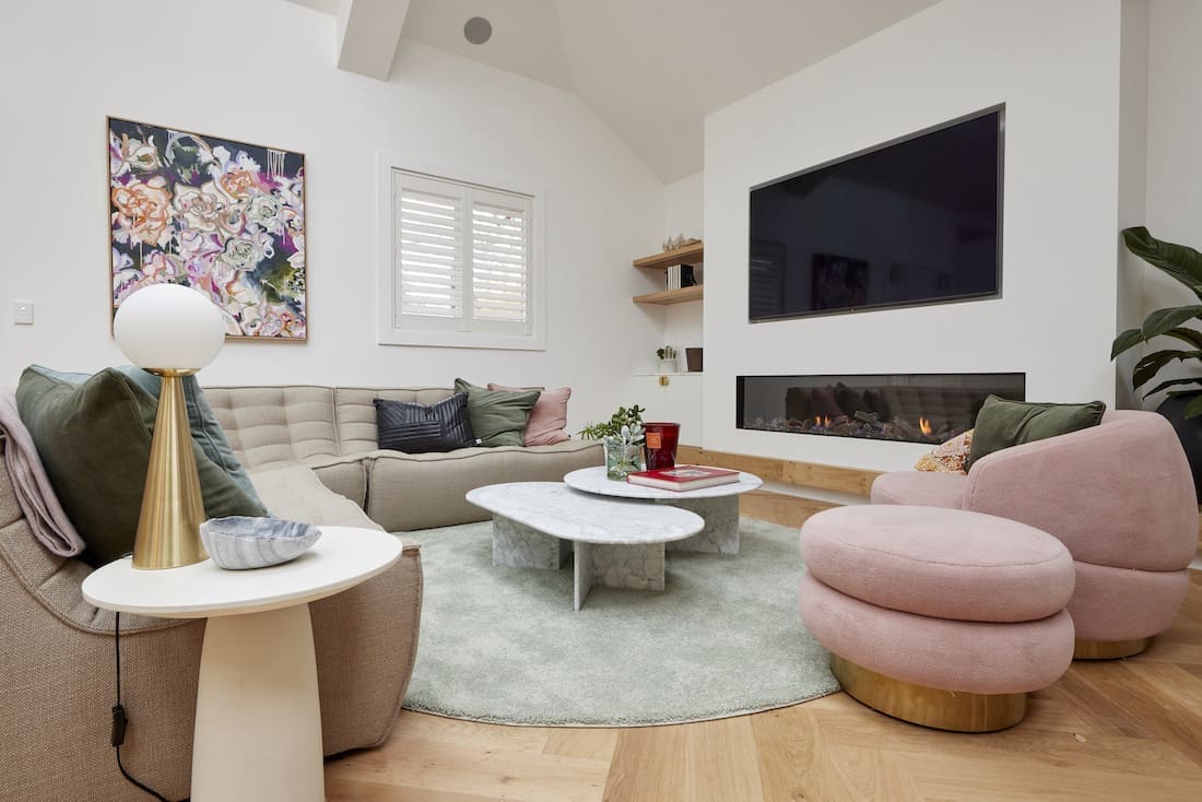 Round rug in living room with curved sofa