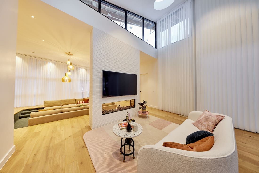 Double sided white brick fireplace with glass front