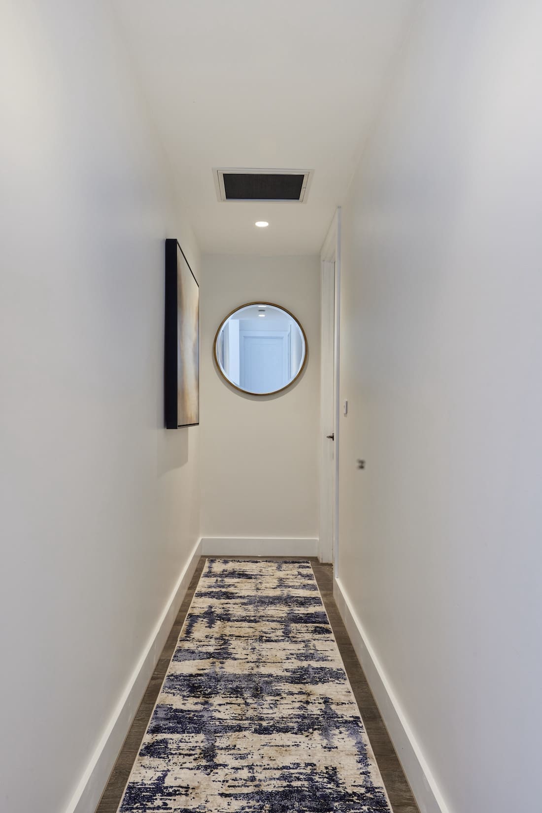 Hallway runner rug and round mirror