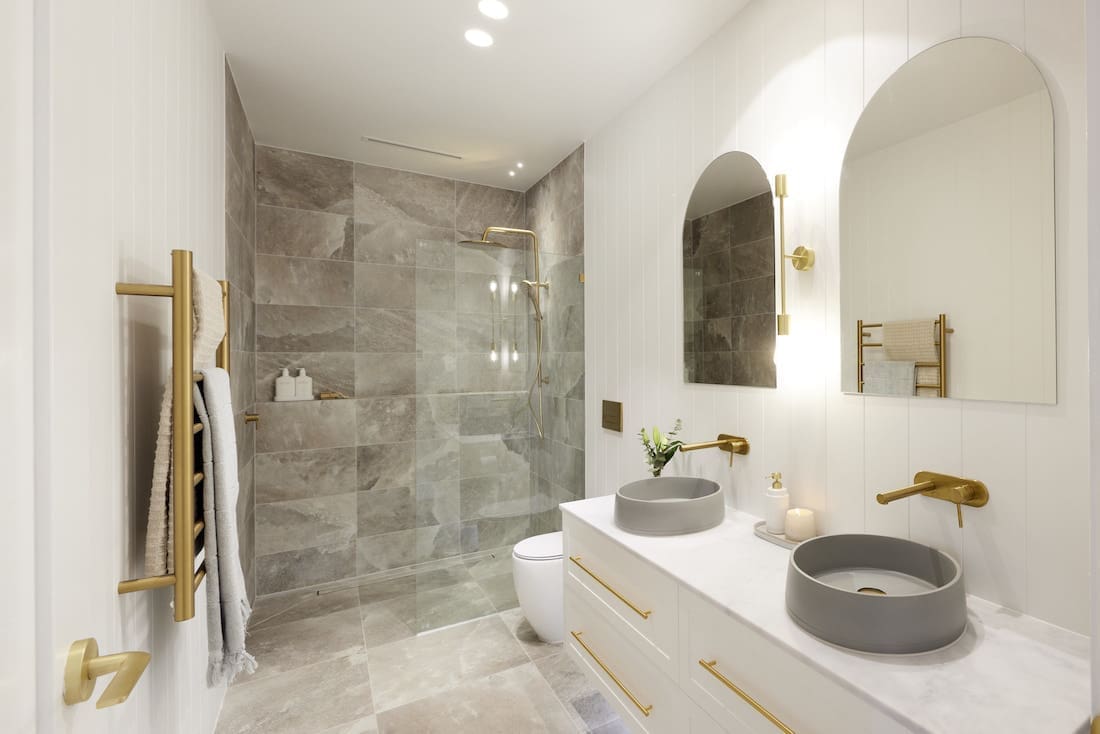 Bathroom with arch mirrors and grey tiled shower