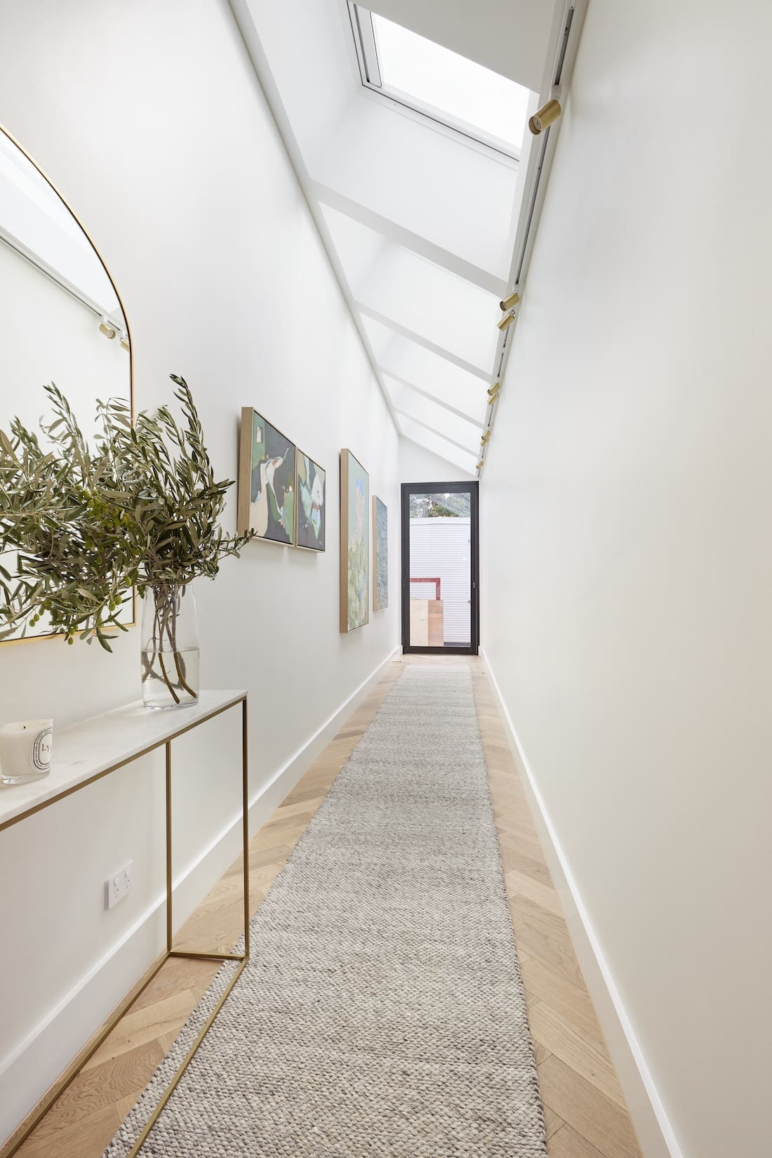 Console table in hallway with skylights