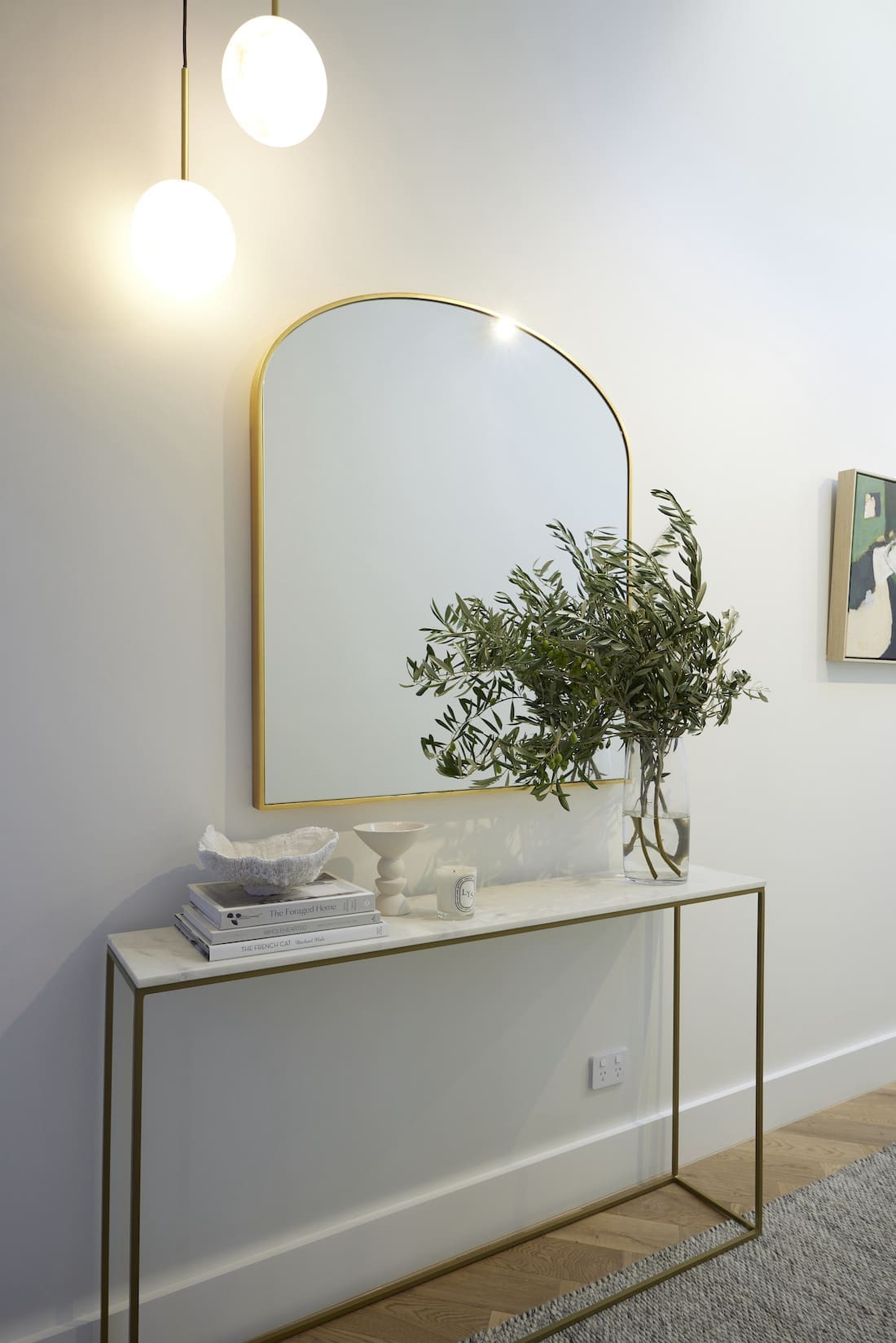Arch mirror over hallway console table