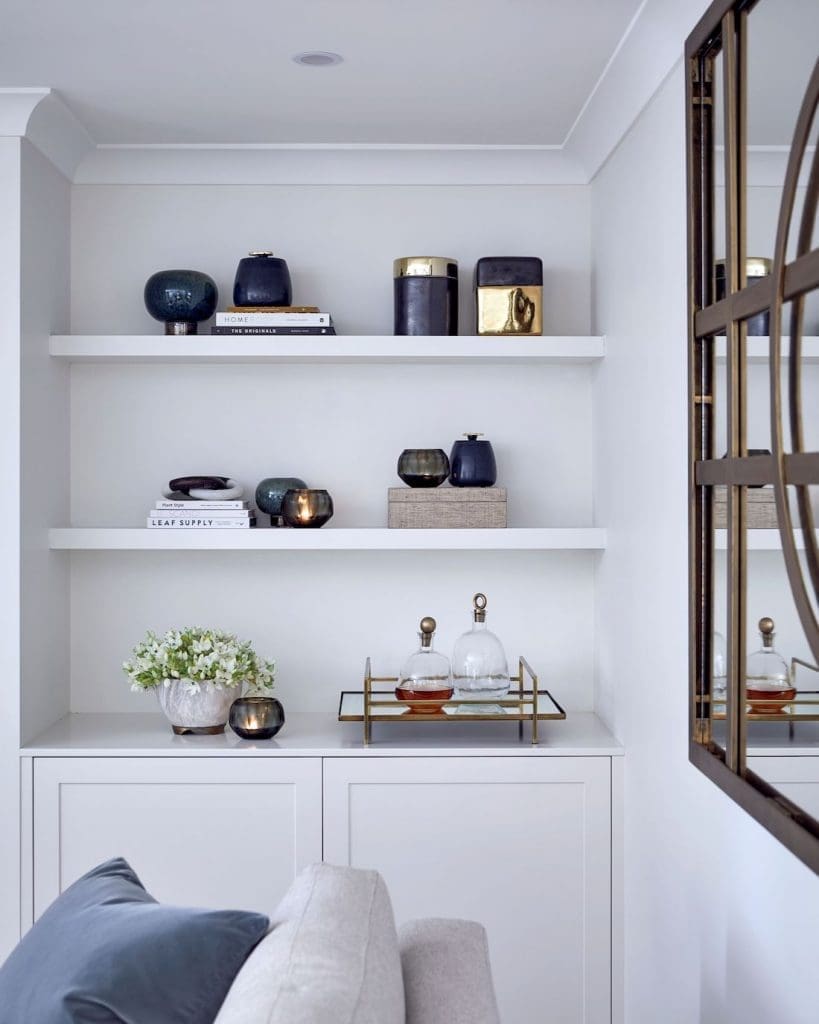White painted cabinetry with styled shelves