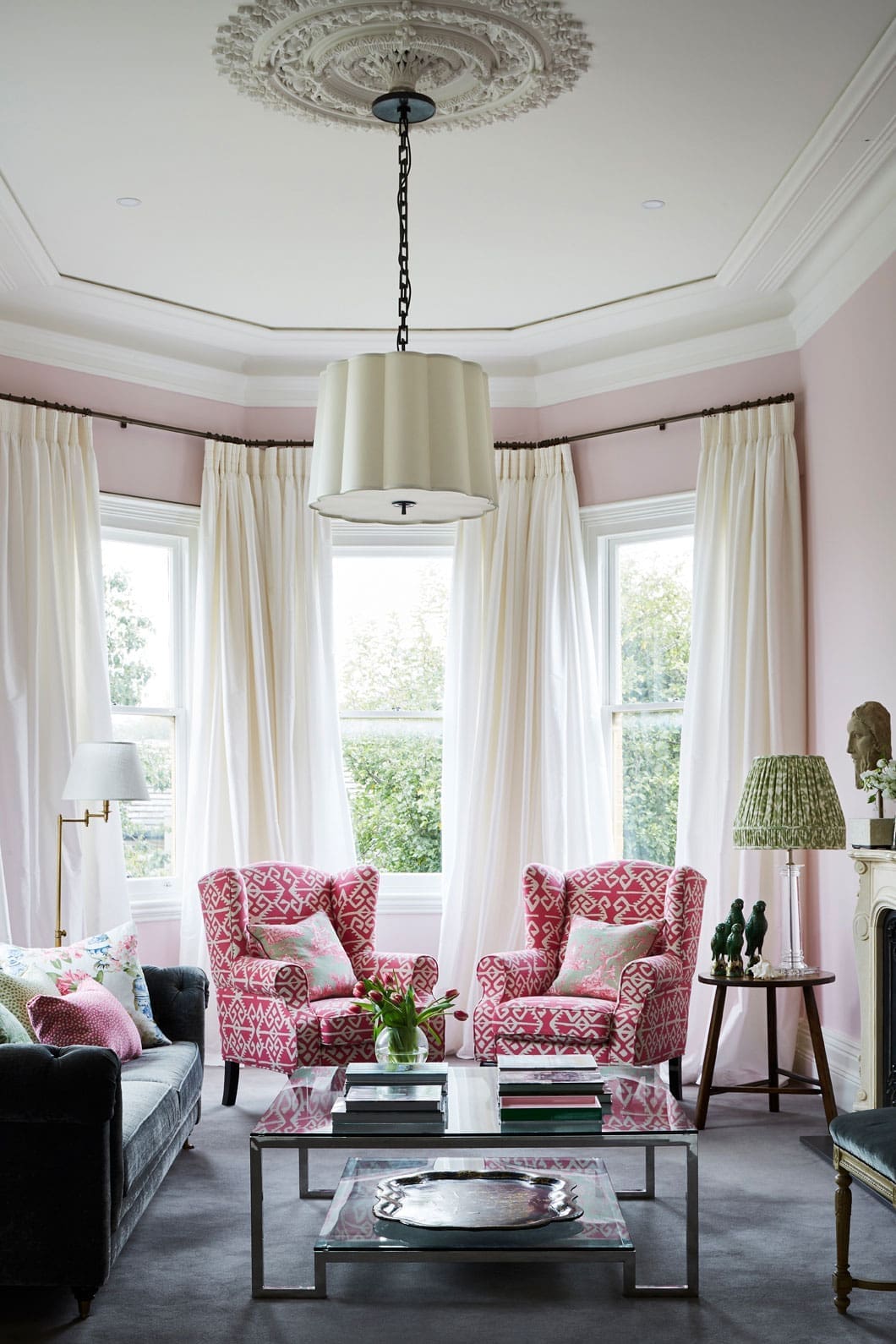 Pink walls in heritage house with ornate ceiling