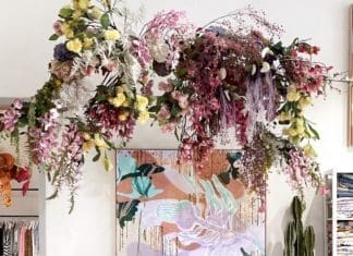 Floral display hanging from ceiling with Sarah Leslie artwork