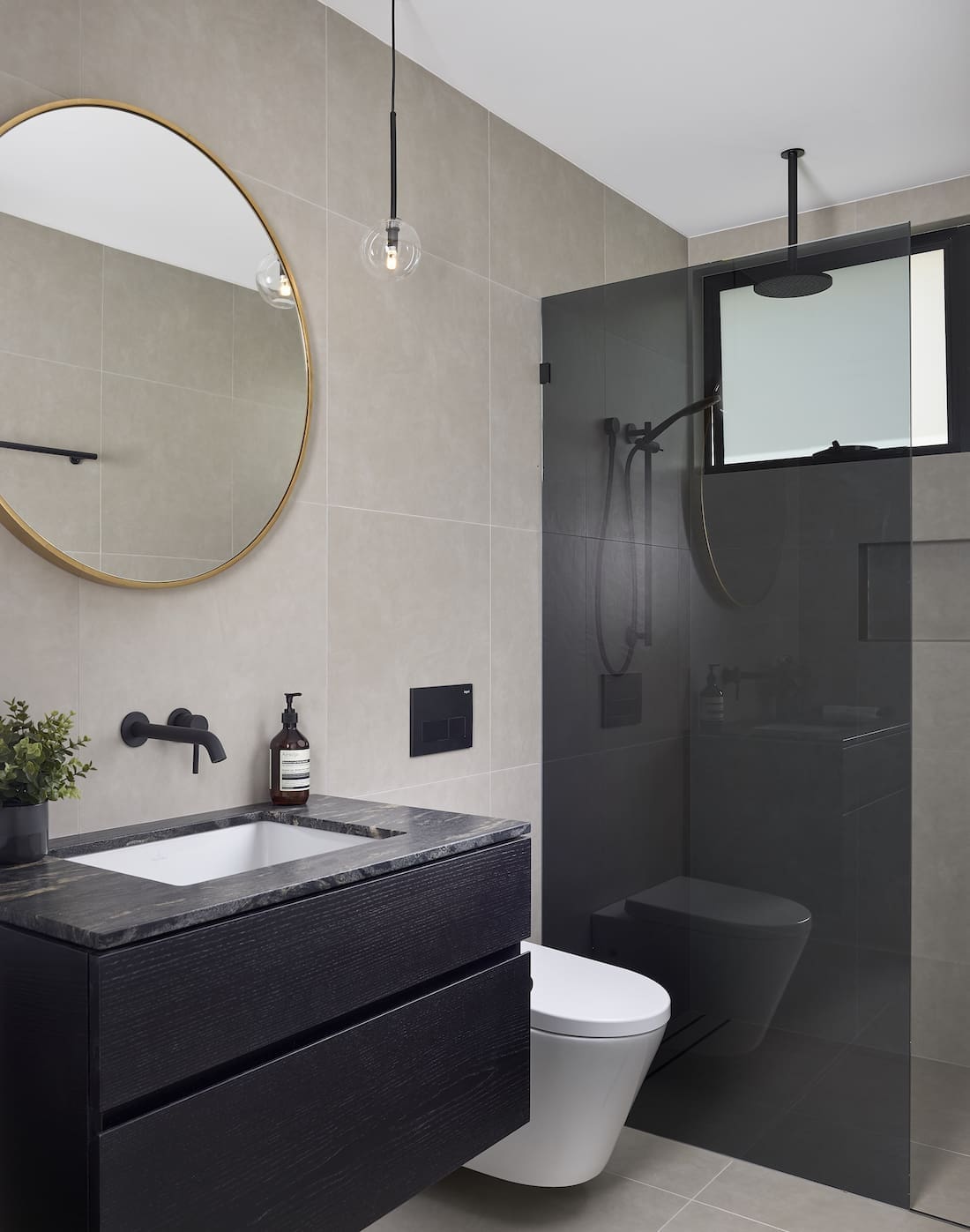 Black bathroom with round mirror