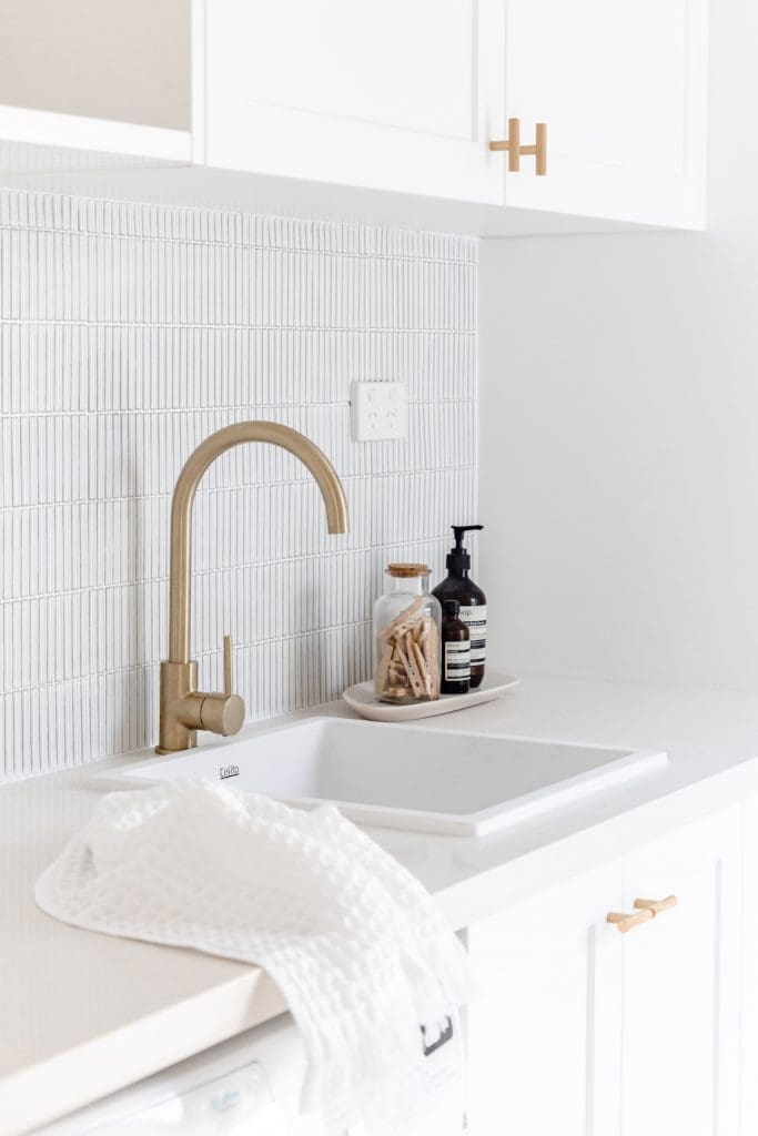 Gold tap in white laudry