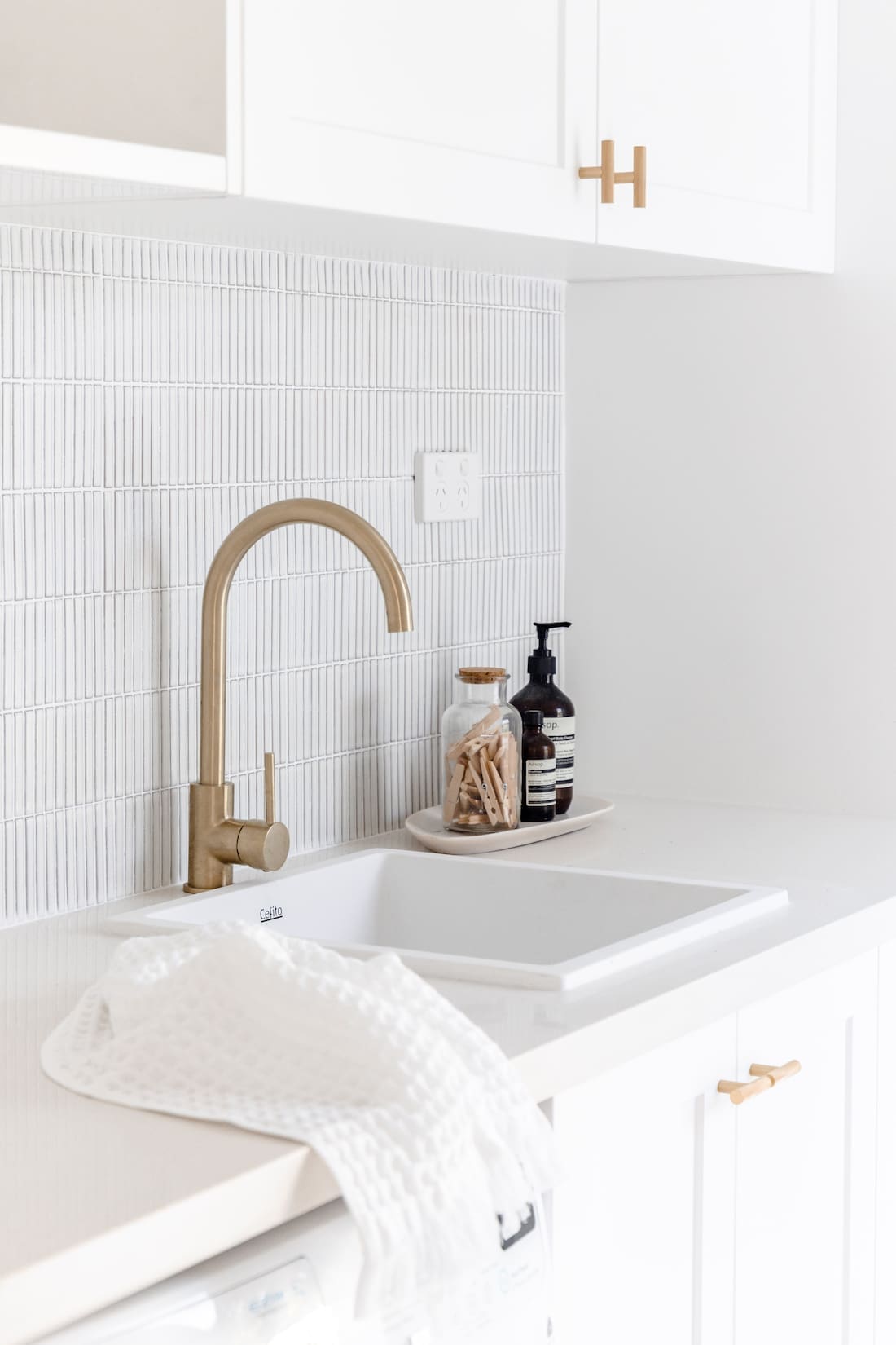 Gold tap in white laudry
