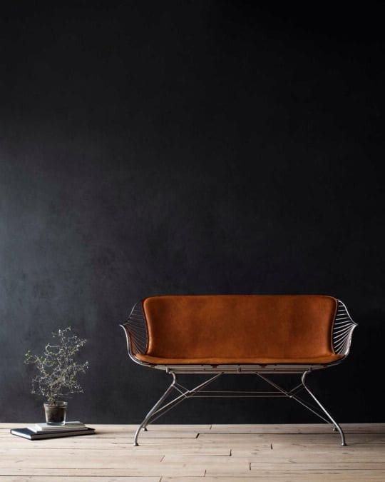 Black wall with metal seat