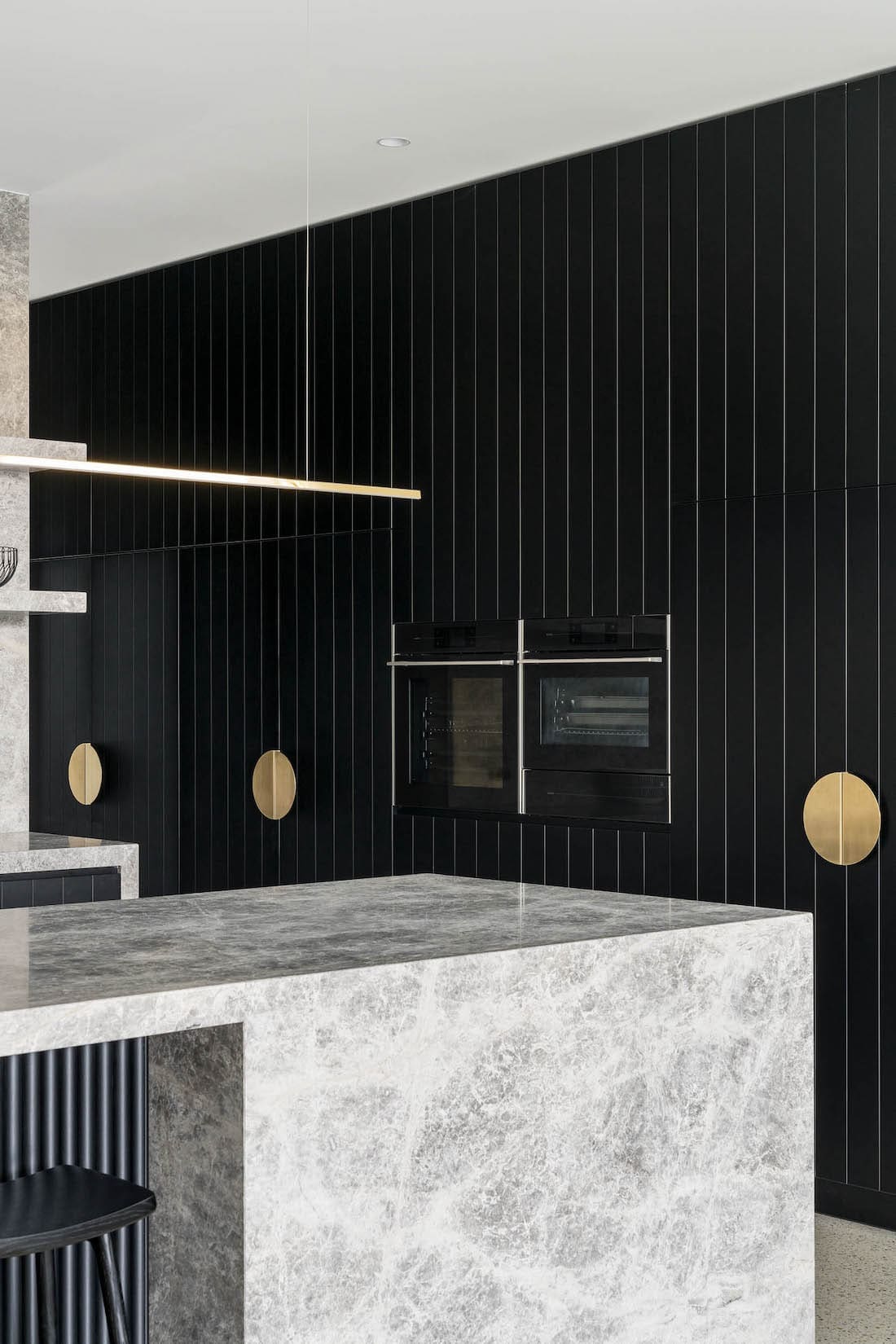 First Avenue Homes Hampton St black kitchen with brass accents