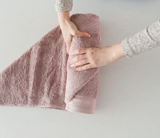 Roll the bath towel tightly