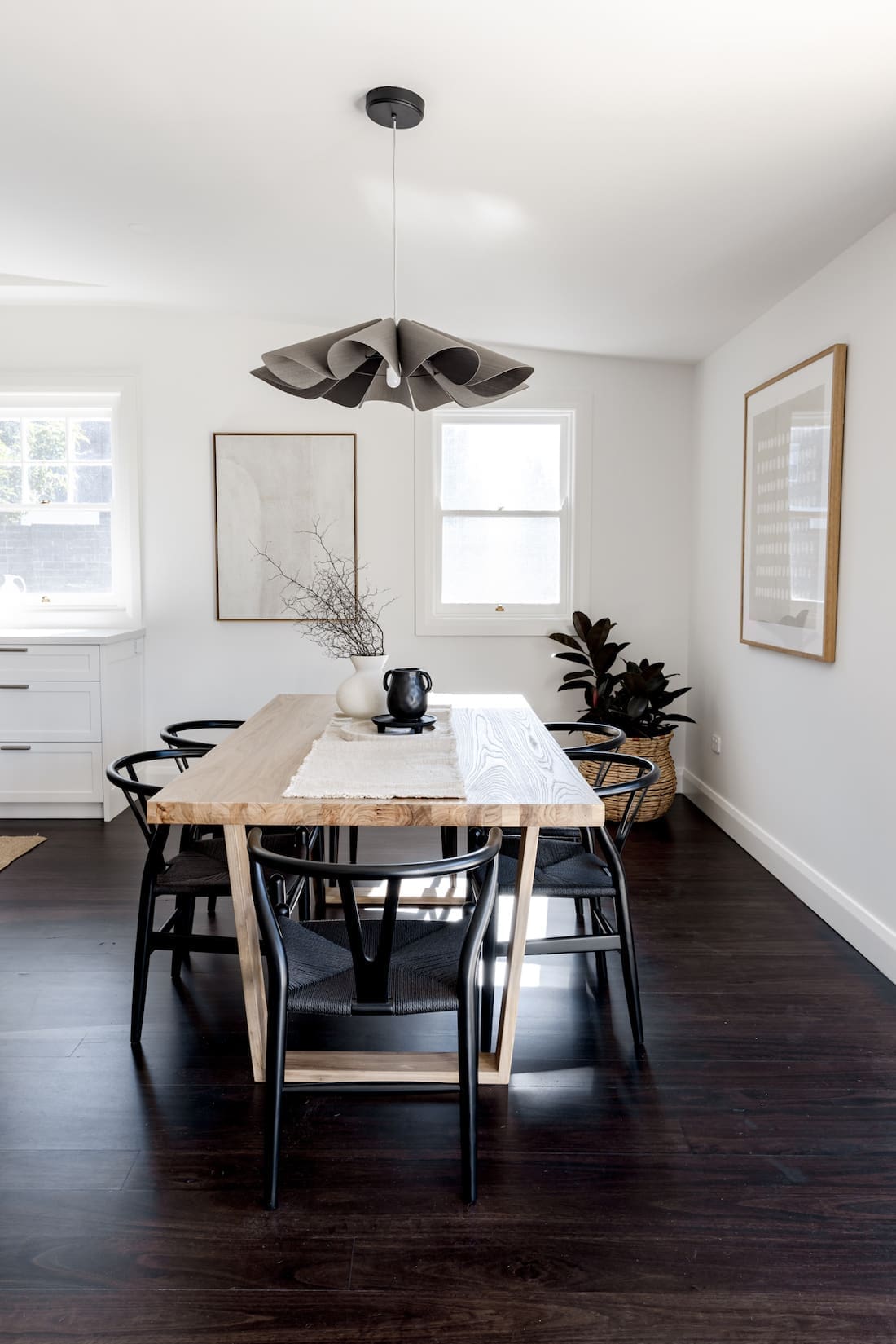 Timber dining table with black wishbone chairs
