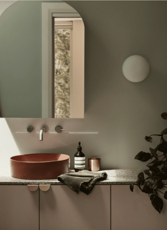terracotta basin in a green bathroom