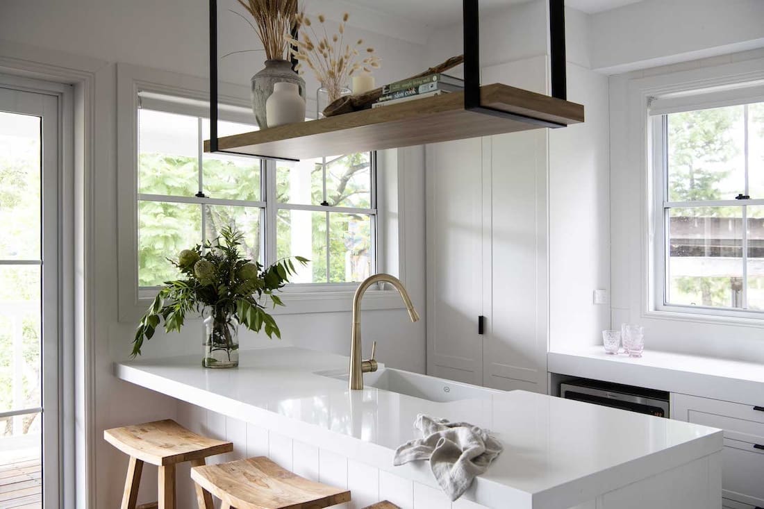 White benchtop in kitchen with gooseneck tap