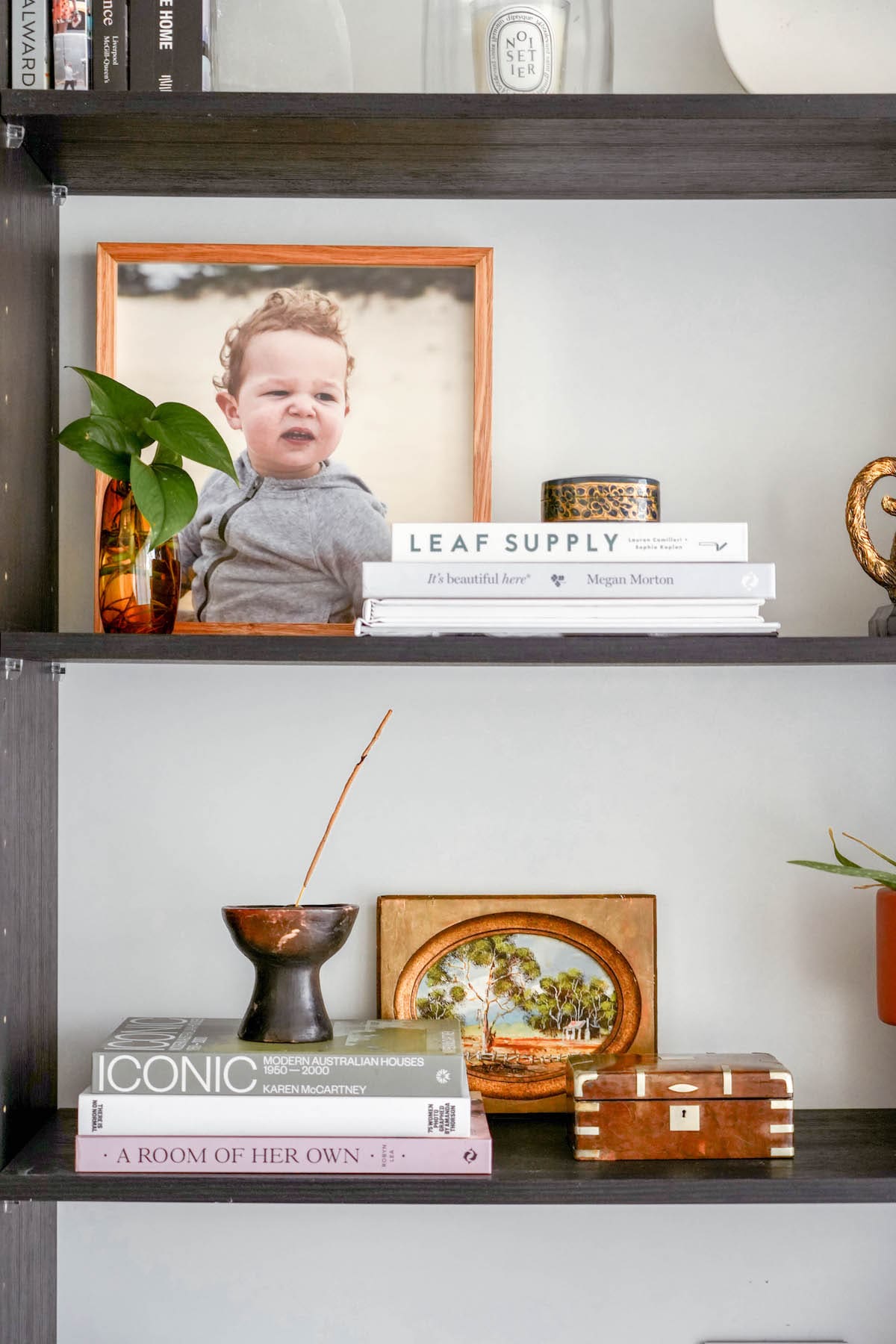 mix vintage decor into a modern home bookshelf