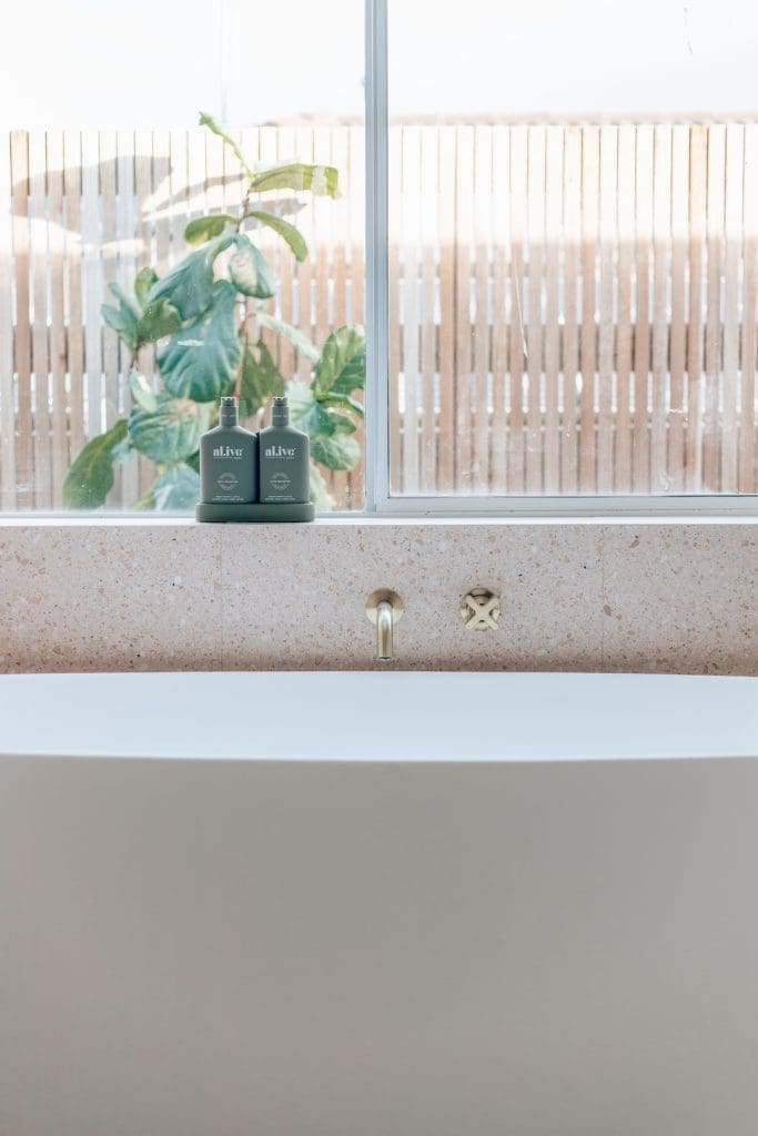 Beautiful bath tub next to window with bath wall spout