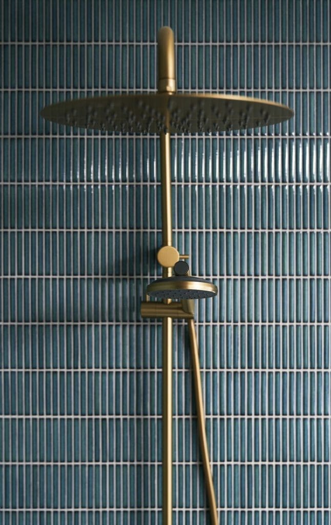 Blue kit kat tiles with brass shower rose