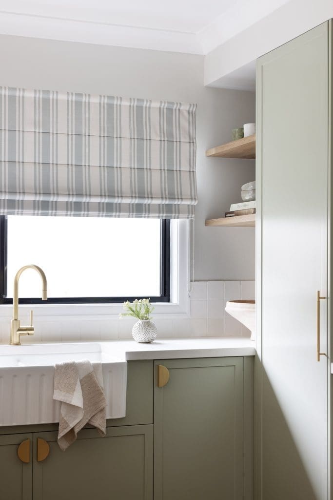 Farmhouse sink and striped blind in modern farmhouse kitchen