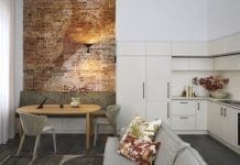 Exposed brick dining nook opening into living and kitchen in Tribeca Brewery apartment by The Stylesmiths